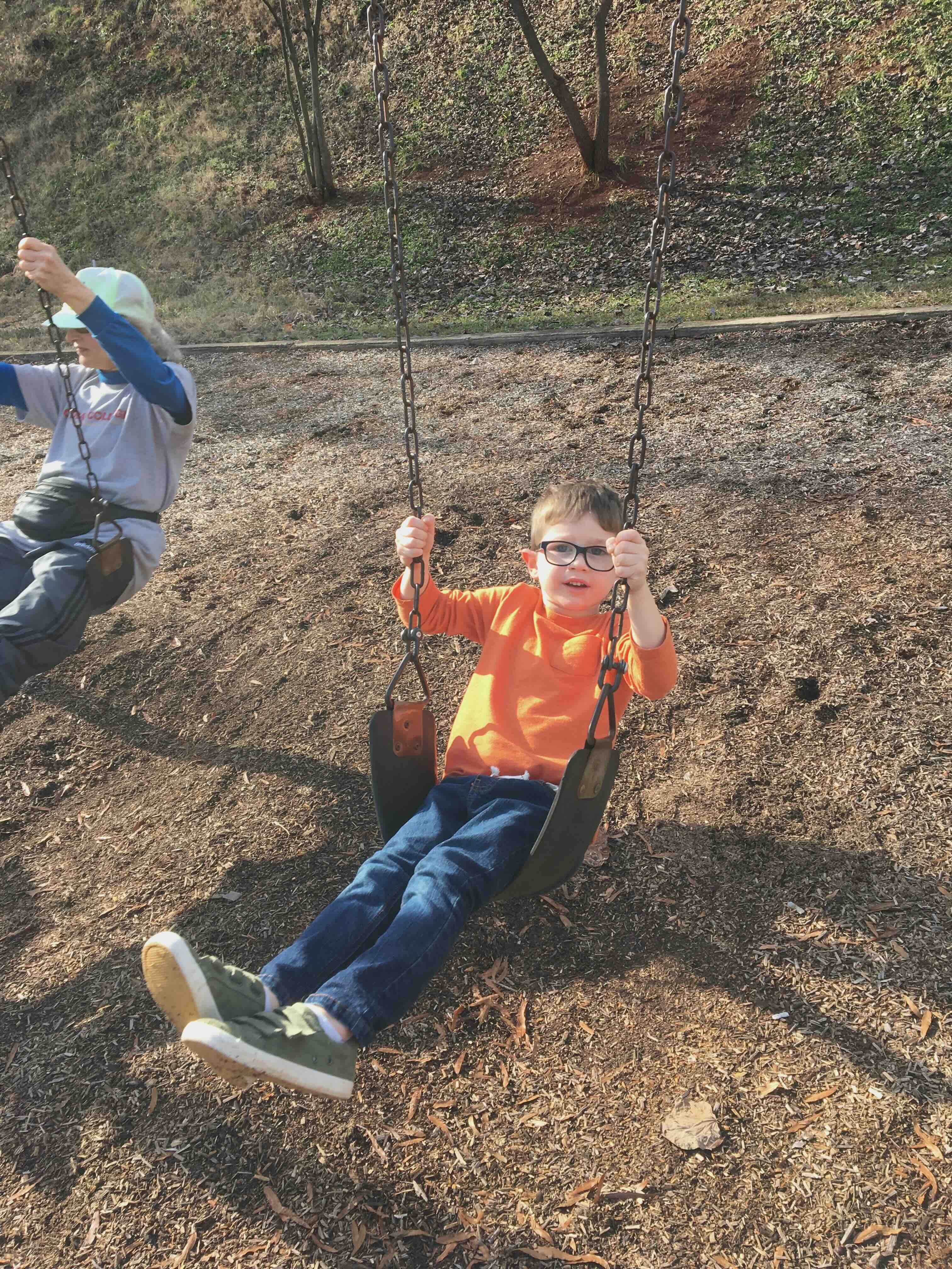 Marcia swinging with her grandson at McPherson Park