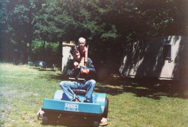 Tim is holding his push-along mower and I am on my Dixon mower