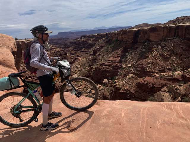 Big canyon below and bedrock under Norm right up to the edge